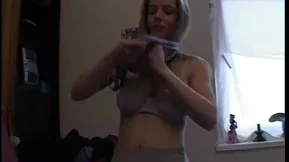 A blonde girl with big tits is playing with her pussy