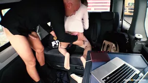 A young white girl shows her panties while riding in the backseat of a car.