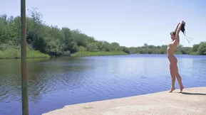 Natalia E. enjoying some outdoor fun by the lake.