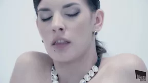 Hot lesbian scene with latex and pussy licking in a white boxx decorated room.